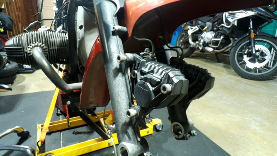 A BMW motorcycle on a stand with its front wheel off