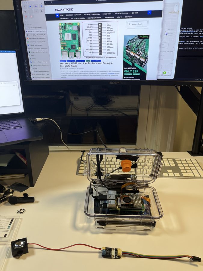 A Raspberry Pi 5 sitting inside the clear case on a desk