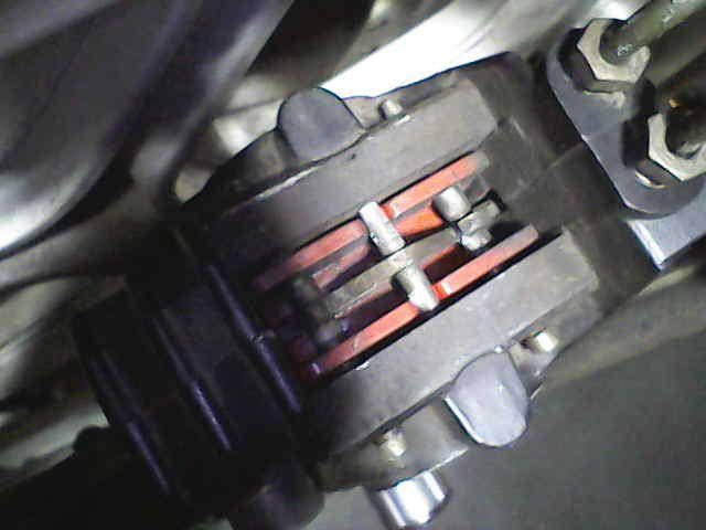 Close-up of brake pads inside a caliper